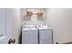Functional laundry area featuring a modern washer and dryer and shelving for storage at 8724 Wardle Ct, Wake Forest, NC 27587