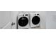 Convenient laundry room featuring modern, front load washer and dryer at 8724 Wardle Ct, Wake Forest, NC 27587