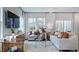 Bright living room with large windows, hardwood floors, neutral decor, and modern furnishings at 8724 Wardle Ct, Wake Forest, NC 27587
