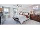Bright main bedroom featuring a decorative accent wall, neutral colors, and plush carpeting at 8724 Wardle Ct, Wake Forest, NC 27587
