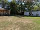 Large backyard featuring multiple outbuildings, mature trees, and spacious outdoor area at 901 Vandora Ave, Garner, NC 27529