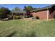 Spacious backyard with a wooden deck, brick home and lush landscaping at 901 Vandora Ave, Garner, NC 27529