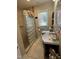 Bright bathroom featuring a glass block shower, large mirror, and a window providing natural light at 901 Vandora Ave, Garner, NC 27529