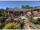 Charming outdoor wooden deck with seating area and lush landscaping at 901 Vandora Ave, Garner, NC 27529