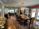 Open-concept dining room showcasing a large table set for a feast and hardwood floors at 901 Vandora Ave, Garner, NC 27529
