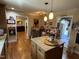 Warm kitchen featuring an island, hardwood floors, and natural light from nearby rooms at 901 Vandora Ave, Garner, NC 27529