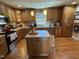 Kitchen with wood cabinets, stainless steel appliances, hardwood floors, and an island at 901 Vandora Ave, Garner, NC 27529