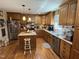 Cozy kitchen with wood cabinets, stainless steel appliances, and a central island at 901 Vandora Ave, Garner, NC 27529