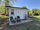 White outbuilding with a small deck and vintage furniture at 901 Vandora Ave, Garner, NC 27529