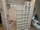Walk-in shower with glass block partition and tiled walls offering a luxurious bathing experience at 901 Vandora Ave, Garner, NC 27529