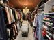 Spacious walk-in closet with custom shelving, chandelier, and central island for storage and organization at 901 Vandora Ave, Garner, NC 27529