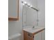 Bathroom featuring a light wood vanity with a white sink, bright lighting, and a large mirror at 497 Summerwalk Cir # 497, Chapel Hill, NC 27517