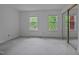 Bright bedroom with neutral carpet, two windows offering leafy views, and mirrored closet doors at 497 Summerwalk Cir # 497, Chapel Hill, NC 27517