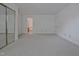 Bedroom showcasing neutral carpet, closet with mirrored doors, and a door leading to the en suite bathroom at 497 Summerwalk Cir # 497, Chapel Hill, NC 27517