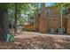 Side exterior of the townhome highlighting the brickwork and outdoor AC units at 497 Summerwalk Cir # 497, Chapel Hill, NC 27517