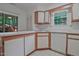 Well-lit kitchen featuring white cabinets, laminate counters, and stainless-steel sink at 497 Summerwalk Cir # 497, Chapel Hill, NC 27517