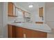 Galley-style kitchen with white cabinets, window, and laminate countertop at 497 Summerwalk Cir # 497, Chapel Hill, NC 27517