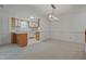 Open floor plan showcasing the kitchen with breakfast bar and adjacent carpeted dining area at 497 Summerwalk Cir # 497, Chapel Hill, NC 27517