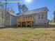 Spacious backyard featuring a light-blue siding home and wooden deck, perfect for outdoor entertaining at 95 Autumnwood Ln, Spring Hope, NC 27882