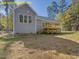 Large backyard features a light-blue siding home with a spacious, natural-wood deck with stair access at 95 Autumnwood Ln, Spring Hope, NC 27882