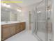 Bright bathroom featuring double vanity, walk-in shower with gray tiling, and white-patterned flooring at 95 Autumnwood Ln, Spring Hope, NC 27882