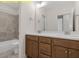 Bathroom featuring double vanity, spacious counter tops, and tiled shower with tub at 95 Autumnwood Ln, Spring Hope, NC 27882