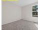 Light-filled bedroom with neutral carpet and a window with a backyard view at 95 Autumnwood Ln, Spring Hope, NC 27882