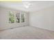 This bedroom features carpeted floors and large windows that let in plenty of natural light at 95 Autumnwood Ln, Spring Hope, NC 27882