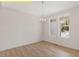 Bright dining room with hardwood floors, decorative chandelier, and natural light pouring in from two large windows at 95 Autumnwood Ln, Spring Hope, NC 27882