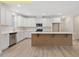 This kitchen has stainless steel appliances, a large island and white cabinetry at 95 Autumnwood Ln, Spring Hope, NC 27882