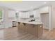 This kitchen has stainless steel appliances, a large island and white cabinetry at 95 Autumnwood Ln, Spring Hope, NC 27882