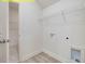 Bright laundry room with shelving and washer/dryer hookups at 95 Autumnwood Ln, Spring Hope, NC 27882