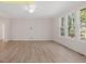 This living room features hardwood floors and large windows that let in plenty of natural light at 95 Autumnwood Ln, Spring Hope, NC 27882