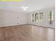 This living room features hardwood floors and large windows that let in plenty of natural light at 95 Autumnwood Ln, Spring Hope, NC 27882