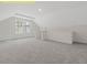 Carpeted loft area with a large window and ample natural light at 95 Autumnwood Ln, Spring Hope, NC 27882