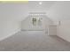 Spacious loft area with vaulted ceilings, neutral carpet, and a bright window at 95 Autumnwood Ln, Spring Hope, NC 27882