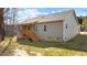 Inviting back exterior of a home with vinyl siding and a charming wooden deck and stairs at 95 Leisure Ln # 9, Louisburg, NC 27549