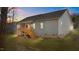 Back exterior of a home featuring a cozy wooden deck with stairs, complemented by vinyl siding at 95 Leisure Ln # 9, Louisburg, NC 27549