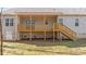 A backyard view of the home with wood porch, railing, and stairs at 95 Leisure Ln # 9, Louisburg, NC 27549