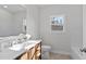 Bright bathroom featuring a stylish vanity with wood accents, tile floors, and a large mirror at 95 Leisure Ln # 9, Louisburg, NC 27549