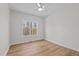 Minimalist bedroom with wood floors, a ceiling fan, and a window with a view of the outdoors at 95 Leisure Ln # 9, Louisburg, NC 27549
