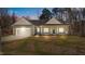 Charming single-story home featuring a two-car garage and a welcoming front porch at dusk at 95 Leisure Ln # 9, Louisburg, NC 27549