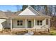 Inviting single-story home featuring a welcoming front porch and manicured landscaping at 95 Leisure Ln # 9, Louisburg, NC 27549