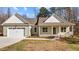 Charming single-story home featuring a two-car garage and a welcoming front porch during the day at 95 Leisure Ln # 9, Louisburg, NC 27549