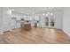 Spacious kitchen area featuring a kitchen island and dining area with access to a balcony at 95 Leisure Ln # 9, Louisburg, NC 27549