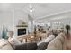 Bright, open-concept living room with fireplace, seamlessly flowing into kitchen and dining area at 95 Leisure Ln # 9, Louisburg, NC 27549