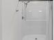Clean shower with modern fixtures and striped shower curtain at 95 Leisure Ln # 9, Louisburg, NC 27549