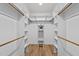 Walk-in closet with built-in shelving and hardwood floors at 95 Leisure Ln # 9, Louisburg, NC 27549