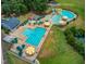 Community pool area featuring multiple pools, lounge chairs, and umbrellas at 100 Winterberry Ln, Holly Springs, NC 27540