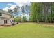 Large, fenced backyard with a deck, ideal for outdoor activities and relaxation at 100 Winterberry Ln, Holly Springs, NC 27540